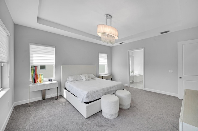 5452 Macoon Way, Westlake, FL 33470 - carpeted bedroom with a tray ceiling, baseboards, and ensuite bathroom