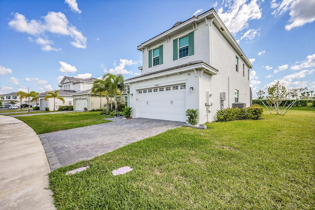 5452 Macoon Way, Westlake, FL 33470 - view of home's exterior with a garage, stucco siding, a lawn, and decorative driveway
