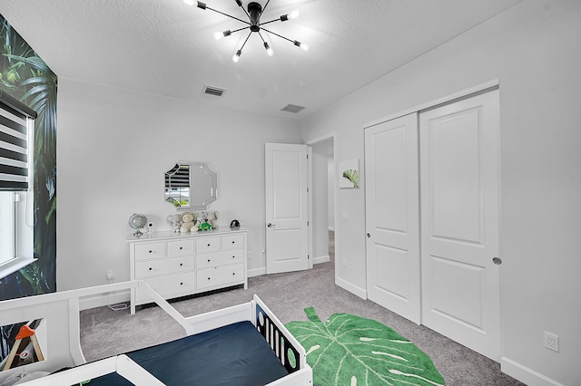 5452 Macoon Way, Westlake, FL 33470 - carpeted bedroom with a chandelier, a closet, baseboards, and a textured ceiling