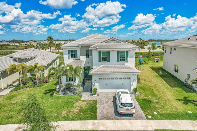 5452 Macoon Way, Westlake, FL 33470 - view of front facade with decorative driveway, a garage, stucco siding, a front lawn, and a tile roof