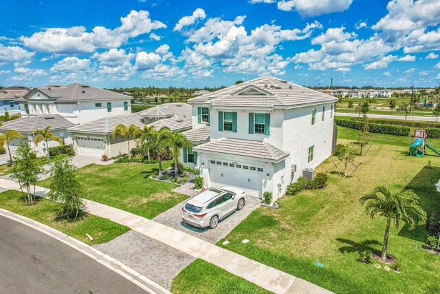 5452 Macoon Way, Westlake, FL 33470 - traditional home featuring decorative driveway, central AC unit, a garage, stucco siding, and a front lawn