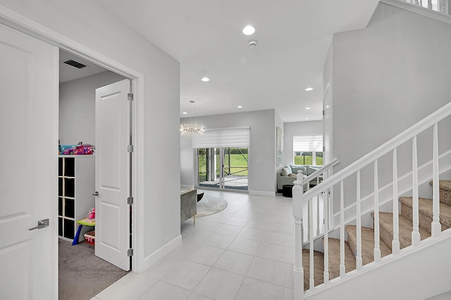 5452 Macoon Way, Westlake, FL 33470 - hallway featuring recessed lighting, stairs, tile patterned floors, baseboards, and a chandelier