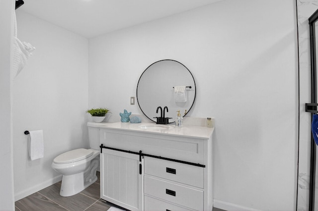 9370 SW 8th St Unit 410, Boca Raton, FL 33428 - bathroom featuring toilet, vanity, baseboards, and wood finished floors