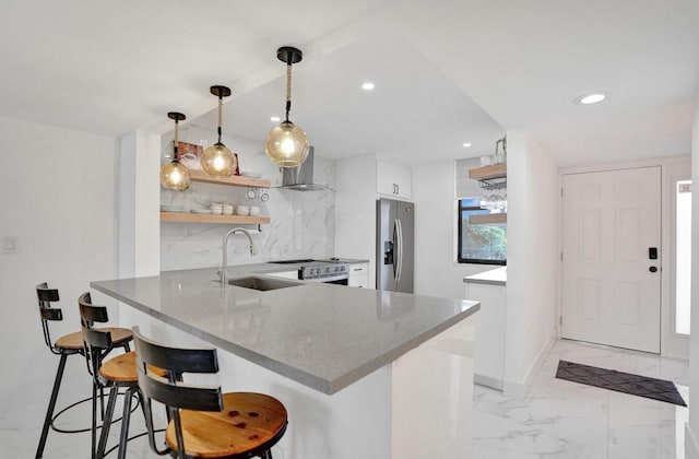 2768 Carambola Cir S Unit 301, Coconut Creek, FL 33066 - kitchen featuring appliances with stainless steel finishes, a sink, open shelves, a peninsula, and wall chimney exhaust hood