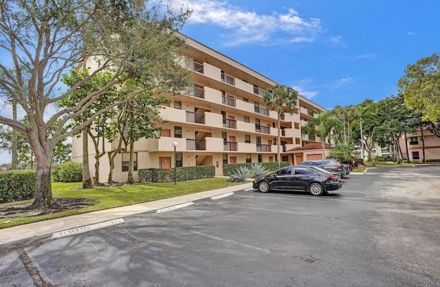 2768 Carambola Cir S Unit 301, Coconut Creek, FL 33066 - view of apartment building / complex featuring uncovered parking