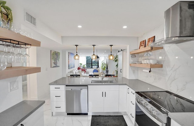 2768 Carambola Cir S Unit 301, Coconut Creek, FL 33066 - kitchen featuring appliances with stainless steel finishes, island range hood, a sink, a peninsula, and open shelves