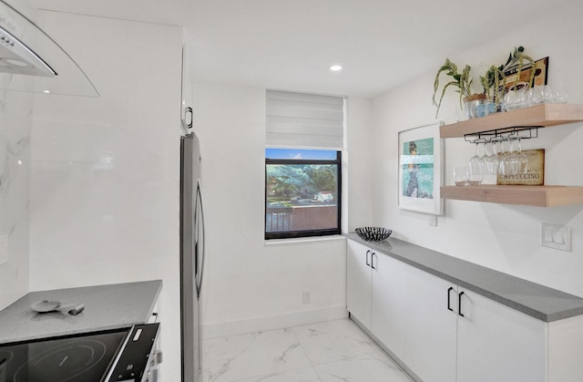 2768 Carambola Cir S Unit 301, Coconut Creek, FL 33066 - kitchen with open shelves, stainless steel fridge with ice dispenser, light marble finish flooring, dark countertops, and white cabinetry