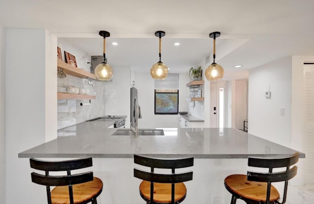2768 Carambola Cir S Unit 301, Coconut Creek, FL 33066 - kitchen featuring open shelves, a peninsula, recessed lighting, and pendant lighting