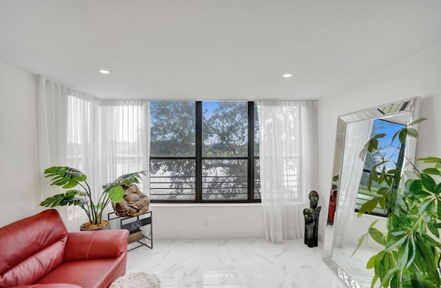 2768 Carambola Cir S Unit 301, Coconut Creek, FL 33066 - living area featuring plenty of natural light, marble finish flooring, and recessed lighting