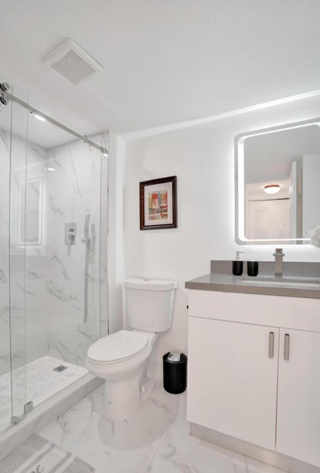 2768 Carambola Cir S Unit 301, Coconut Creek, FL 33066 - bathroom featuring vanity, toilet, a marble finish shower, and marble look tile flooring