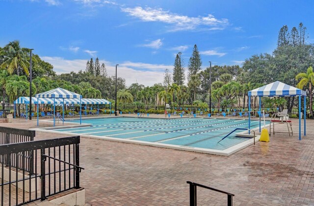 2768 Carambola Cir S Unit 301, Coconut Creek, FL 33066 - view of pool with view of wooded area