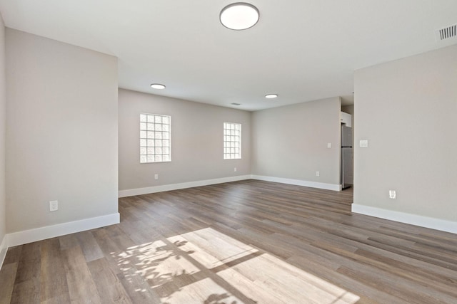 617 54th St, West Palm Beach, FL 33407 - spare room featuring wood finished floors, baseboards, and recessed lighting