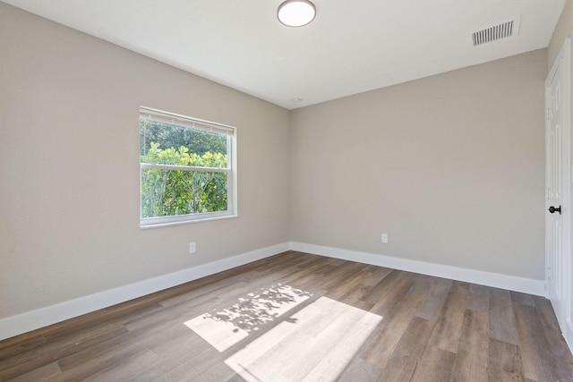 617 54th St, West Palm Beach, FL 33407 - empty room featuring baseboards and wood finished floors