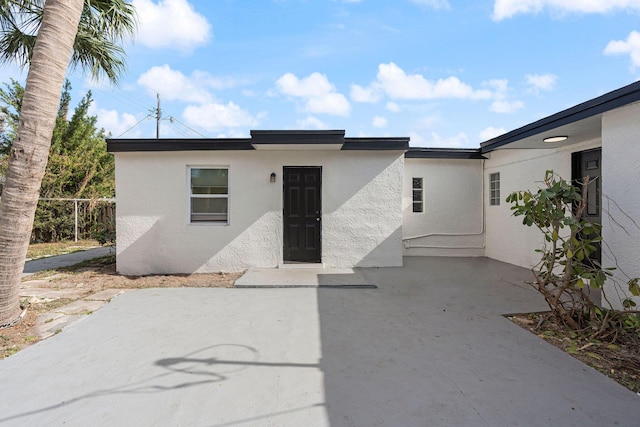 617 54th St, West Palm Beach, FL 33407 - view of front of home with stucco siding and a patio area