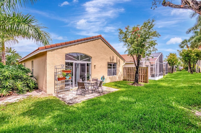 9640 Cherry Blossom Ct, Boynton Beach, FL 33437 - rear view of property featuring stucco siding, a yard, a tiled roof, and a patio