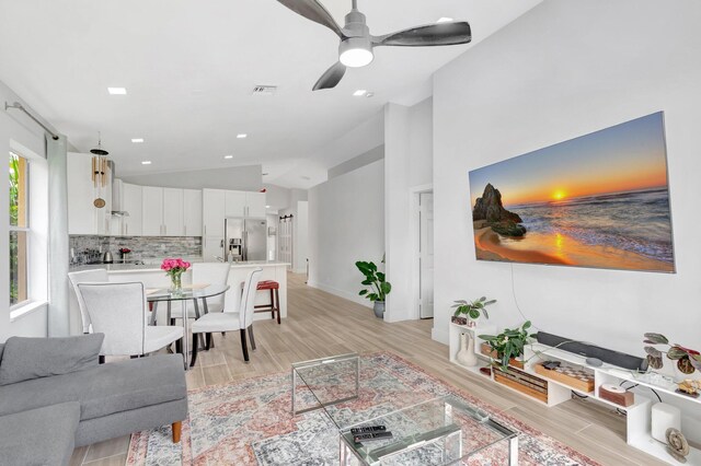 9640 Cherry Blossom Ct, Boynton Beach, FL 33437 - living room with vaulted ceiling, light wood-style flooring, a ceiling fan, recessed lighting, and baseboards