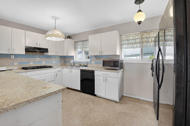 1115 S Seacrest Blvd, Boynton Beach, FL 33435 - kitchen with black appliances, under cabinet range hood, a sink, decorative backsplash, and light countertops