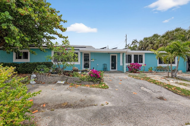 1115 S Seacrest Blvd, Boynton Beach, FL 33435 - ranch-style home with roof mounted solar panels and stucco siding