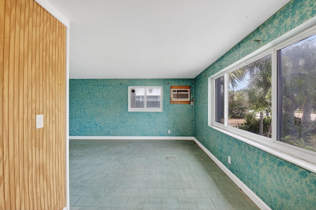 1115 S Seacrest Blvd, Boynton Beach, FL 33435 - empty room with a wall unit AC, wallpapered walls, and baseboards