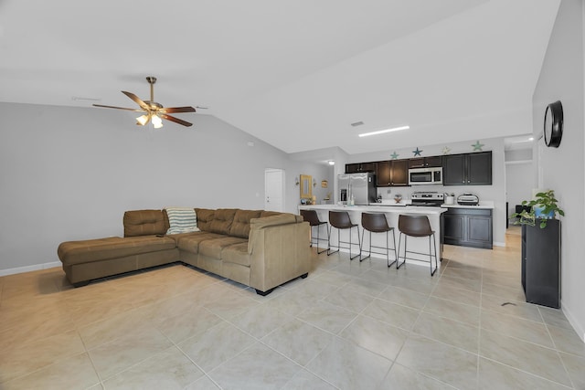 191 SW Glenwood Dr, Port Saint Lucie, FL 34984 - living area with vaulted ceiling, a ceiling fan, light tile patterned flooring, and baseboards