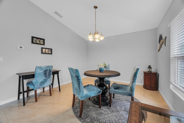 191 SW Glenwood Dr, Port Saint Lucie, FL 34984 - dining room featuring a chandelier, lofted ceiling, light tile patterned floors, and baseboards