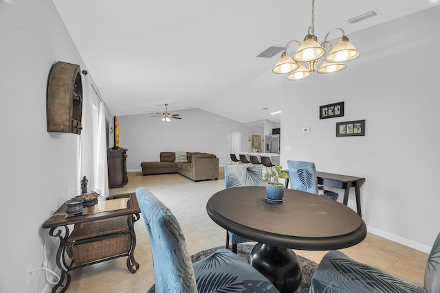 191 SW Glenwood Dr, Port Saint Lucie, FL 34984 - dining area with lofted ceiling, light tile patterned flooring, a ceiling fan, a chandelier, and baseboards
