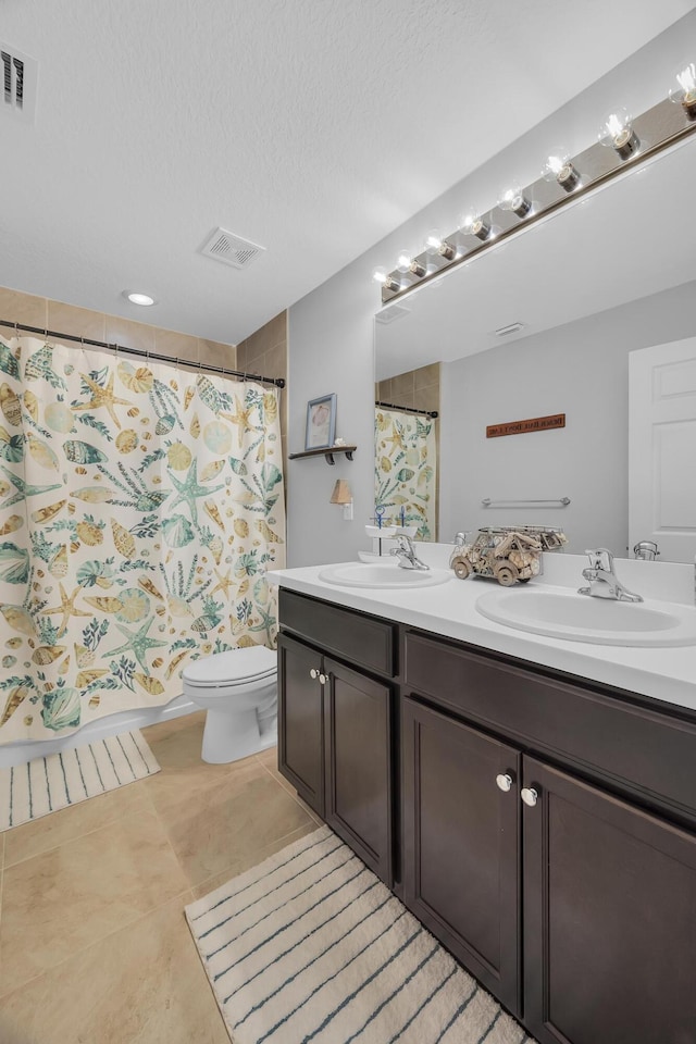 191 SW Glenwood Dr, Port Saint Lucie, FL 34984 - bathroom with double vanity, toilet, tile patterned floors, a textured ceiling, and curtained shower
