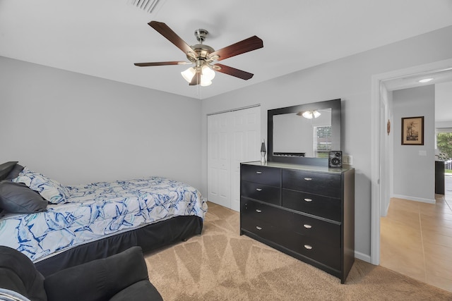 191 SW Glenwood Dr, Port Saint Lucie, FL 34984 - bedroom featuring a closet, baseboards, ceiling fan, and light carpet