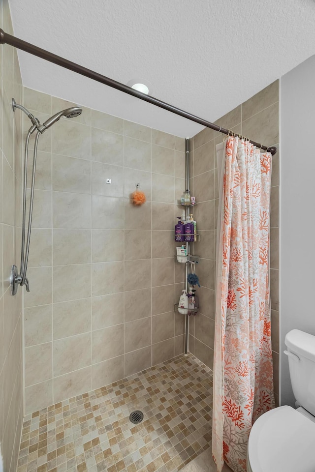 191 SW Glenwood Dr, Port Saint Lucie, FL 34984 - bathroom with a textured ceiling, a shower stall, and toilet