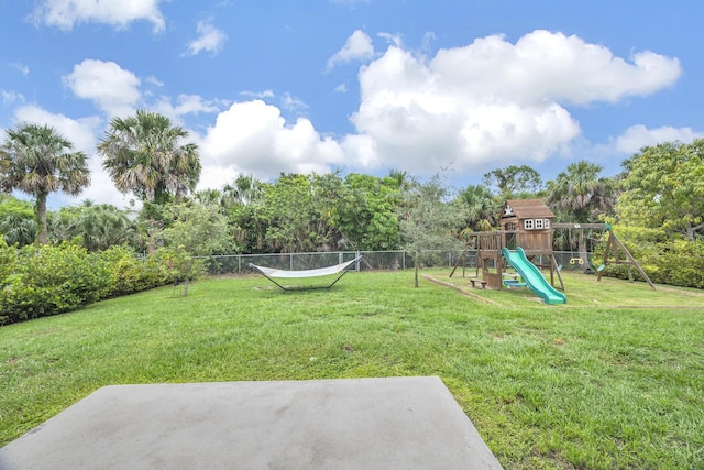 191 SW Glenwood Dr, Port Saint Lucie, FL 34984 - view of yard featuring a playground and view of wooded area