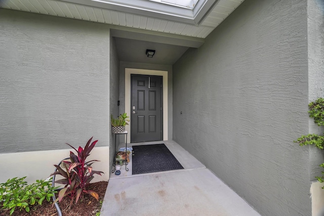 191 SW Glenwood Dr, Port Saint Lucie, FL 34984 - doorway to property featuring stucco siding