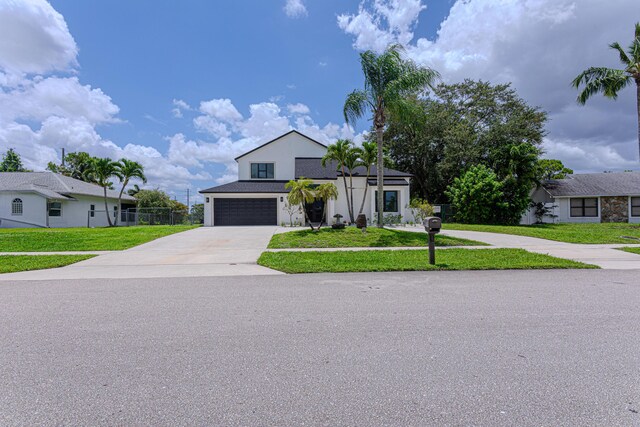 102 Granada St, Royal Palm Beach, FL 33411 - view of front facade with a garage, concrete driveway, a front yard, and stucco siding