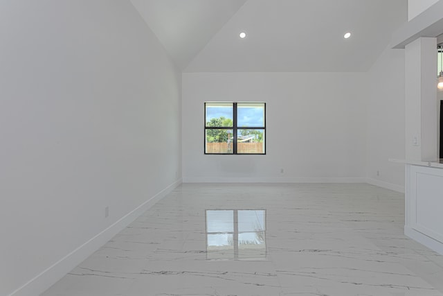 102 Granada St, Royal Palm Beach, FL 33411 - unfurnished room with light marble finish flooring, baseboards, lofted ceiling, and recessed lighting