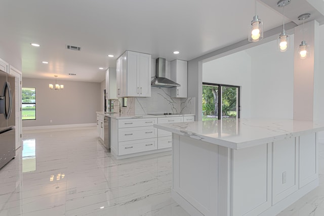 102 Granada St, Royal Palm Beach, FL 33411 - kitchen with wall chimney range hood, light marble finish flooring, black electric cooktop, a chandelier, and recessed lighting