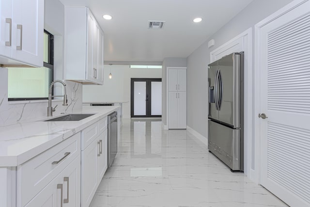 102 Granada St, Royal Palm Beach, FL 33411 - kitchen with appliances with stainless steel finishes, a sink, french doors, white cabinetry, and recessed lighting