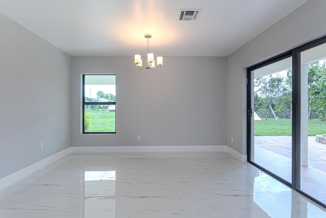 102 Granada St, Royal Palm Beach, FL 33411 - empty room featuring plenty of natural light, a chandelier, light marble finish flooring, and baseboards