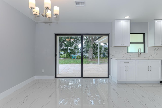 102 Granada St, Royal Palm Beach, FL 33411 - unfurnished dining area featuring a sink, light marble finish floors, baseboards, a chandelier, and recessed lighting
