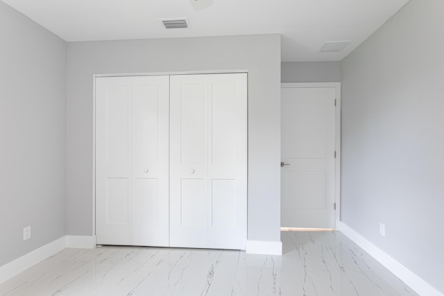 102 Granada St, Royal Palm Beach, FL 33411 - unfurnished bedroom featuring light marble finish flooring, baseboards, and a closet