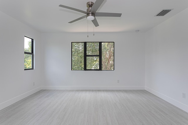102 Granada St, Royal Palm Beach, FL 33411 - empty room with plenty of natural light, ceiling fan, wood finished floors, and baseboards