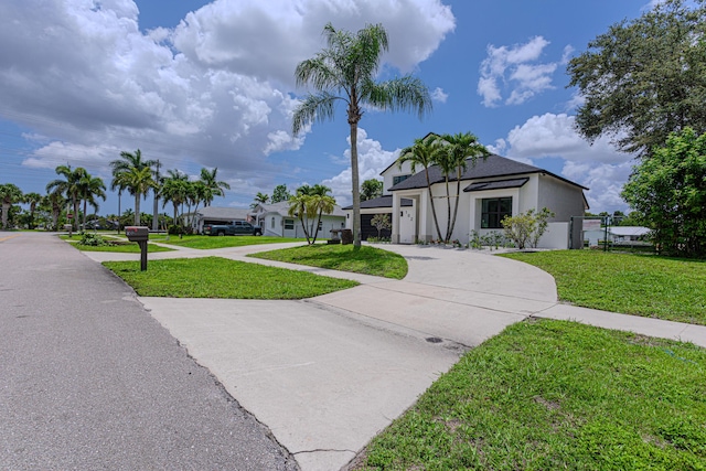 102 Granada St, Royal Palm Beach, FL 33411 - view of front of house with curved driveway and stucco siding