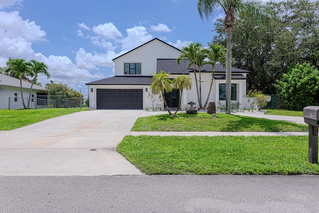 102 Granada St, Royal Palm Beach, FL 33411 - contemporary home featuring an attached garage, concrete driveway, and stucco siding