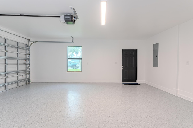 102 Granada St, Royal Palm Beach, FL 33411 - garage featuring electric panel, a garage door opener, and baseboards