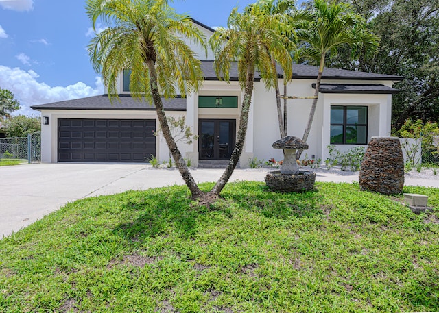 102 Granada St, Royal Palm Beach, FL 33411 - view of front of property with french doors, driveway, stucco siding, and roof with shingles