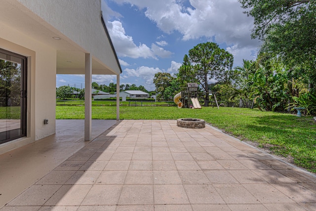 102 Granada St, Royal Palm Beach, FL 33411 - view of patio / terrace featuring a fire pit and a playground