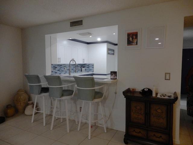 9692 Sills Dr E Unit 103, Boynton Beach, FL 33437 - bar featuring backsplash, light tile patterned flooring, and a sink