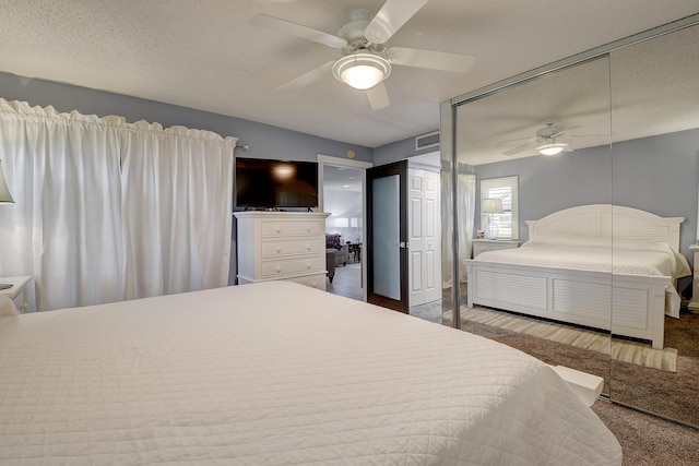 9692 Sills Dr E Unit 103, Boynton Beach, FL 33437 - carpeted bedroom featuring ceiling fan, a textured ceiling, and a closet