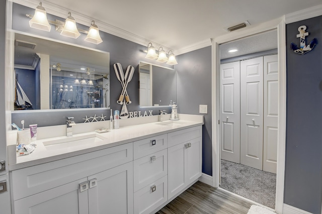 9692 Sills Dr E Unit 103, Boynton Beach, FL 33437 - bathroom featuring double vanity, a shower stall, a closet, ornamental molding, and baseboards