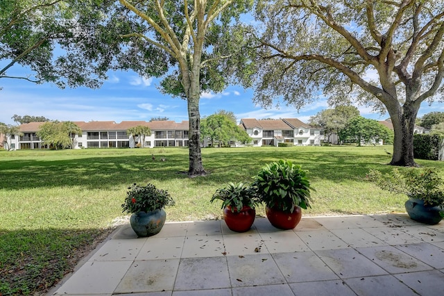 9692 Sills Dr E Unit 103, Boynton Beach, FL 33437 - view of green lawn with a patio area and a residential view