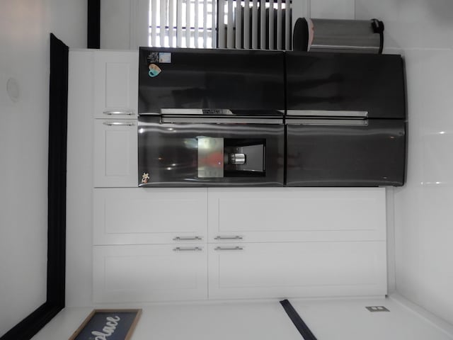 9692 Sills Dr E Unit 103, Boynton Beach, FL 33437 - detailed view of white cabinetry and dark countertops