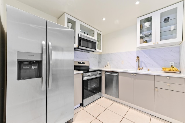 271 Saxony Unit F, Delray Beach, FL 33446 - kitchen with appliances with stainless steel finishes, a sink, light countertops, light tile patterned floors, and recessed lighting